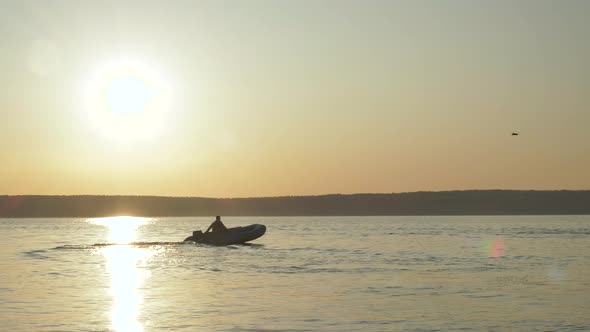 Silhouette Boatman Against Setting Sun alt