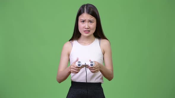 Young Beautiful Asian Businesswoman Playing Games