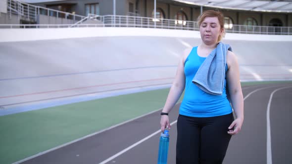 Tired Overweight Woman Walking After Workout alt