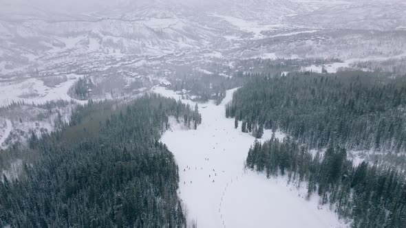 Aerial View of Famous Snowmass Ski Resort Town in Winter Slopes Covered in Snow alt