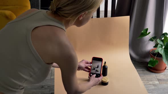 Woman make a photos and video of cosmetics at home. alt
