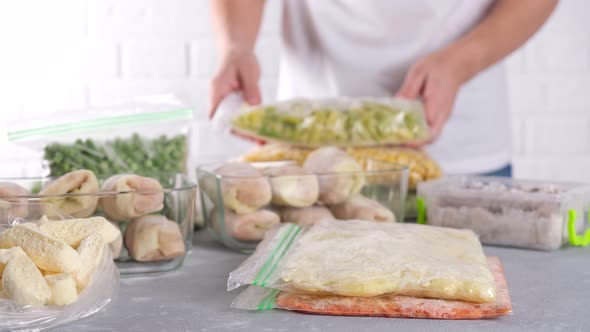 Frozen food in containers and bags on the table. Frozen vegetables.