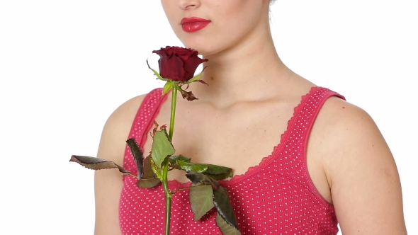 Woman Holding Red Rose and Smiling on a White Background.