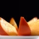 Persimmon Cut Into Slices Rotates on a Black Background - VideoHive Item for Sale