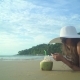 Woman In Swimsuit With Coconut Cocktail Laying On The Beach - VideoHive Item for Sale