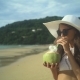 Girl Holding Fresh Cold Coconut At Tropical Beach - VideoHive Item for Sale