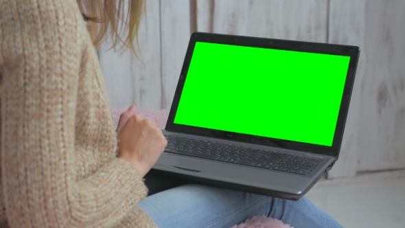 Woman Using Laptop with Green Screen