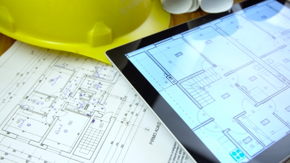 Blueprints and Tablet on Table