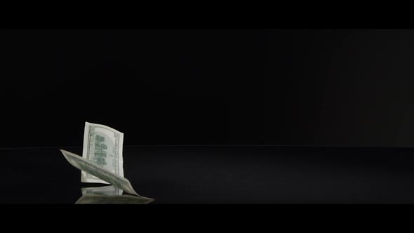 American $100 Bills Falling onto a Reflective Surface - MONEY 0011 alt