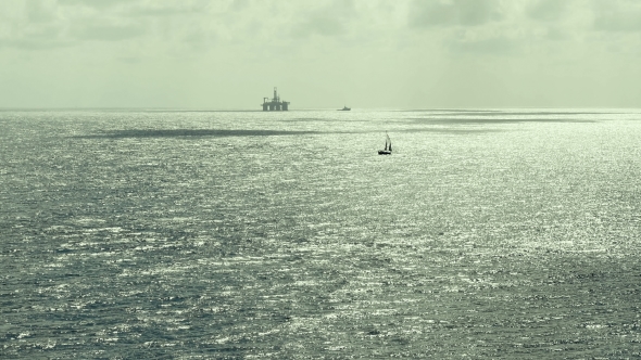 Silhouette Of An Oil Rig Drilling Platform and Ships. Atlantic Ocean. Noon. alt