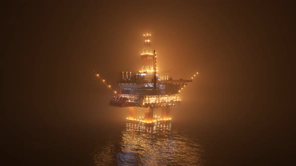 Oil rig on an open ocean during a foggy night. Countless lights illumination. 4K