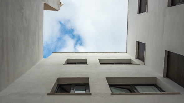 Inside Close Yard. Look at Up. Bottom View. Fast Clouds. . alt