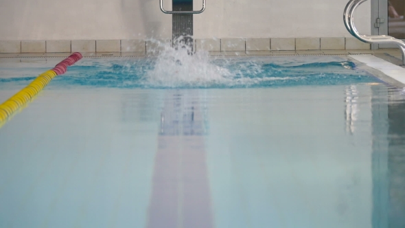 The Woman in Goggles Swimming Butterfly in the Swimming Pool alt
