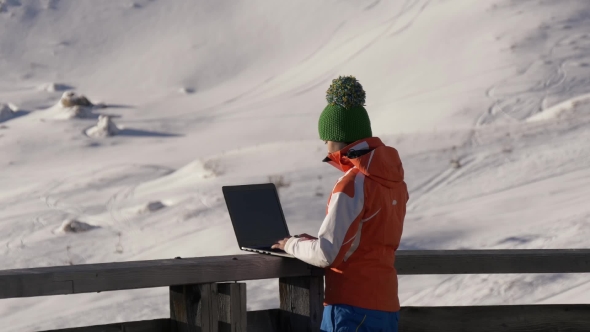 Girl on Vacation in the Mountains with a Laptop