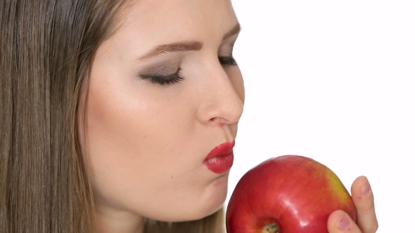 Beautiful Girl Eats Red Apple on White Background