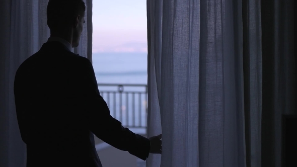 a Man in a Suit Comes on the Balcony alt