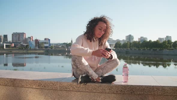 Female Sportsman Relaxing By River alt