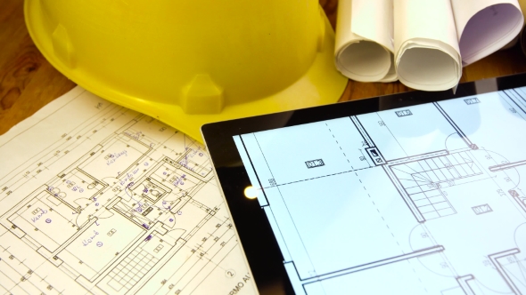 Blueprints, Tablet and Other Stuff on Table