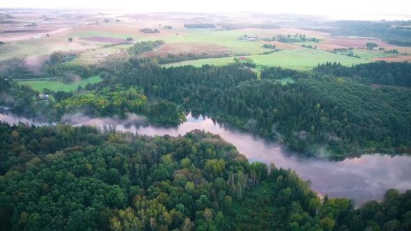 Flying Above Foggy Lake Early in the Morning