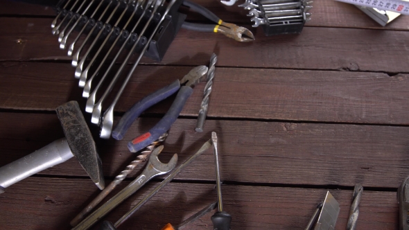 Many Old Rusty Tools and Modern Tablet on Desk