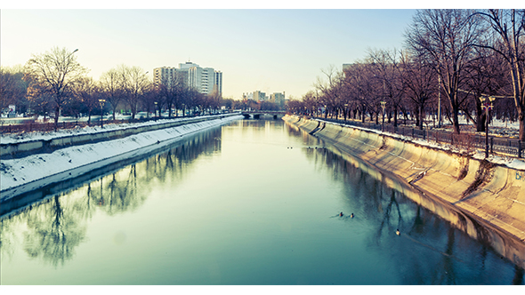 River In The City With A Power Plant In Back alt