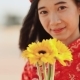 Beautiful Vietnamese Girl in Red Traditional Dress Ao Dai with Yellow Flowers. . - VideoHive Item for Sale