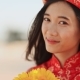 Beautiful Vietnamese Girl in Red Traditional Dress Ao Dai with Yellow Flowers. . - VideoHive Item for Sale