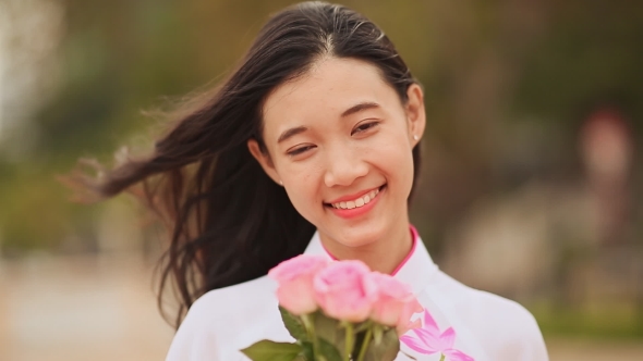 Vietnam Girl in the National Costume and Dress Ao Dai Posing and Smiling for the Camera alt