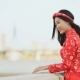 Vietnam Girl in the National Red Dress Ao Dai Posing and Smiling for the Camera on the Seafront of - VideoHive Item for Sale