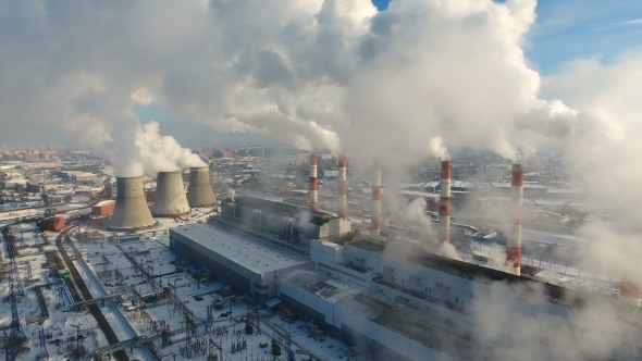 Smokestacks at Industrial Plant Polluting Atmosphere. Winter Aerial. alt