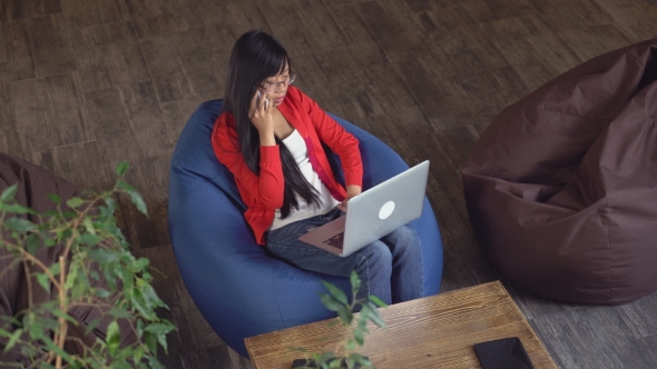Girl Use Smartphone and Laptop Indoors. alt