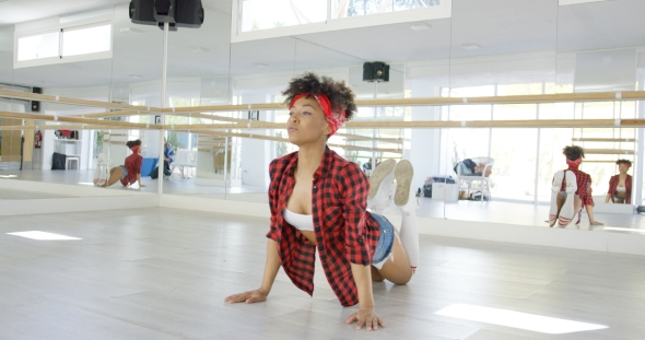 Woman Wearing Shorts Stretches on Hands and Knees alt