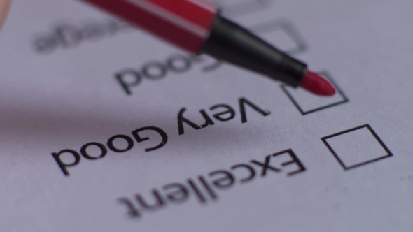 Cropped of Businesswoman Writing on Checklist