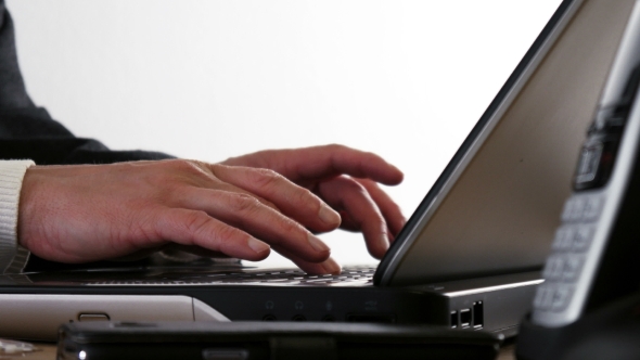 Businessmans Hands Typing on Laptop Keyboard