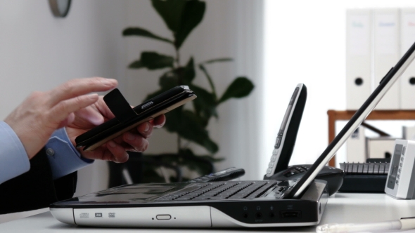 Businessman Using Smartphone in an Office -