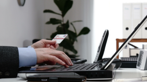 Businessman Using a Credit Cart To Pay Online -