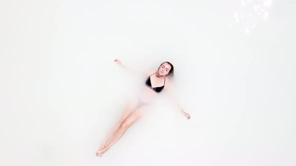 Woman Floating in White Water on Resort