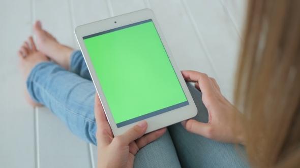 Woman Using Tablet Computer with Green Screen