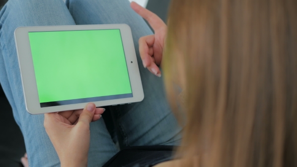 Woman Using Tablet Computer with Green Screen