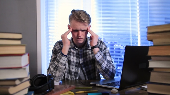Tired and Stressed Young Student in Library alt