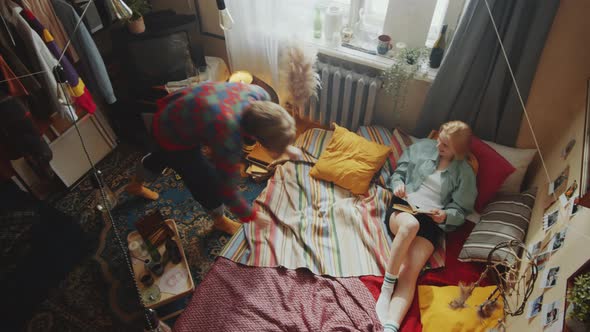 Top View of Young Couple Reading Book in Bedroom alt