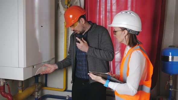 Male Engineer and a Female Checker Check Operability of Equipment in the Boiler Room
