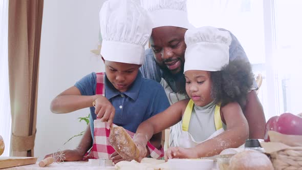 Joyful African American family cooking dinner together. Happy family alt