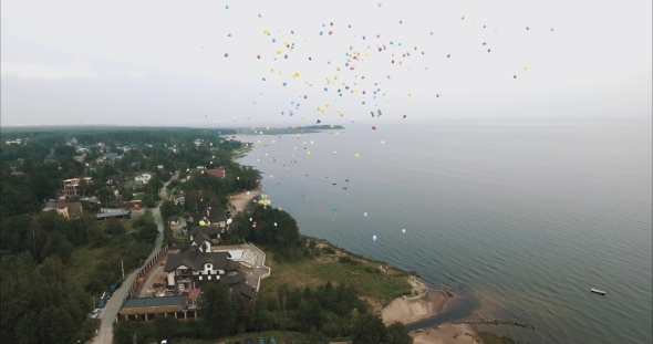 Aerial Shot Lots of Colorful Balloons Flying Up in To Sky Over Sea Shore Beach