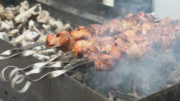 Cooking of Pork Shashlik on Skewers on the Grill