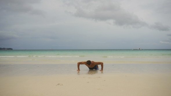 Man Doing Push-ups on the Beach alt