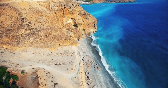 Blue Sea, Waves Breaking in Cliffs at Shore