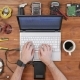 Man Software Engineer Working with a Laptop and an External Hard Drive. Wooden Table Top View - VideoHive Item for Sale