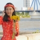 Beautiful Vietnamese Girl in Red Traditional Dress Ao Dai with Yellow Flowers - VideoHive Item for Sale