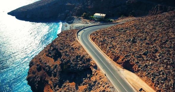 Flying above Road by Seashore